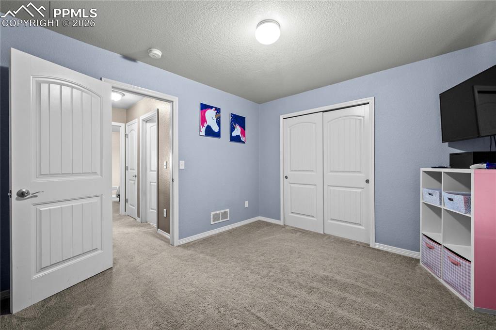 Image 12 of 24: Upper level bedroom