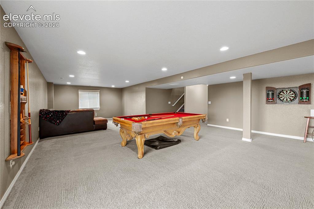 Image 16 of 23: Spacious entertainment area featuring recessed lighting, light-colored carp