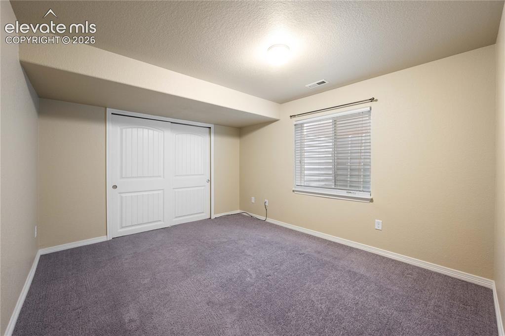 Image 18 of 23: Basemet bedroom