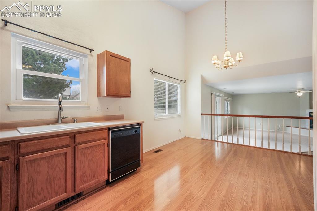 Image 11 of 45: Spacious room featuring a large arched window with natural light, vaulted c