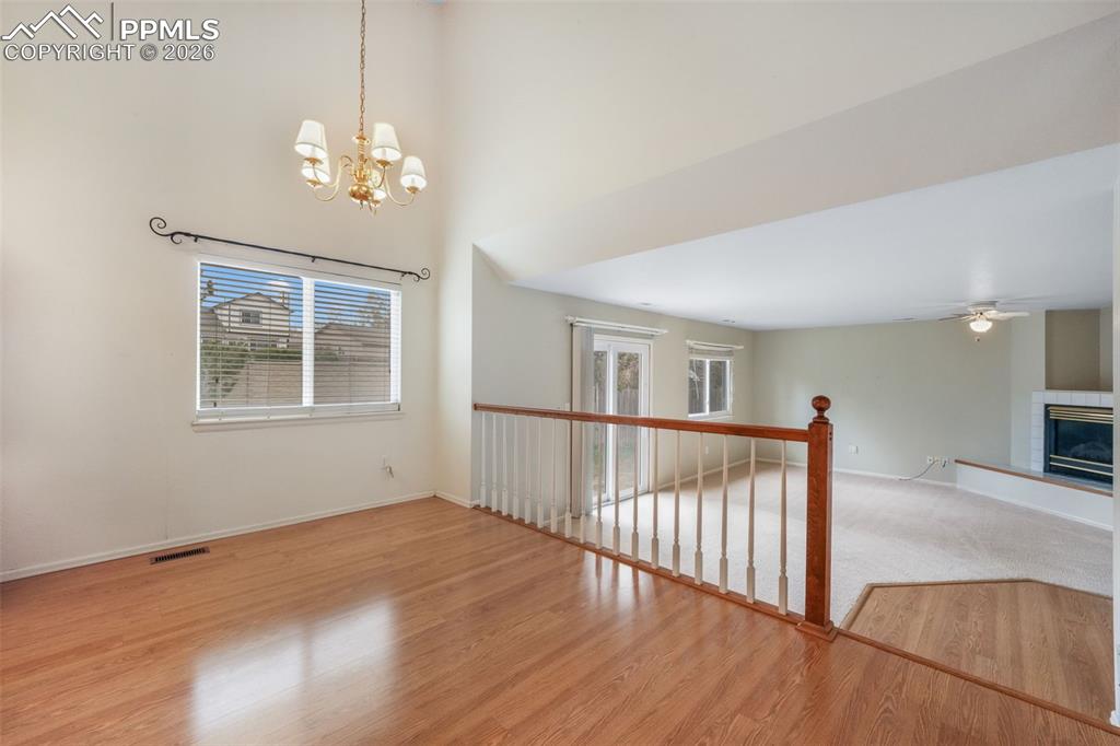 Image 13 of 45: Kitchen featuring wood-finish flooring, ample cabinetry, and light-toned co