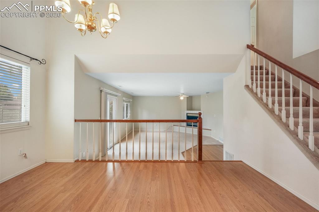Image 14 of 45: Kitchen featuring wood-finish flooring, vaulted ceilings, perimeter cabinet
