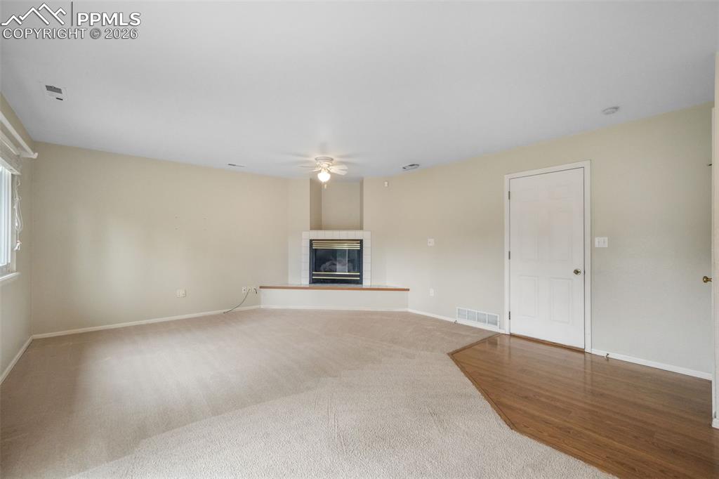 Image 15 of 45: Kitchenette featuring wood-finish flooring, light wood cabinetry, white cou