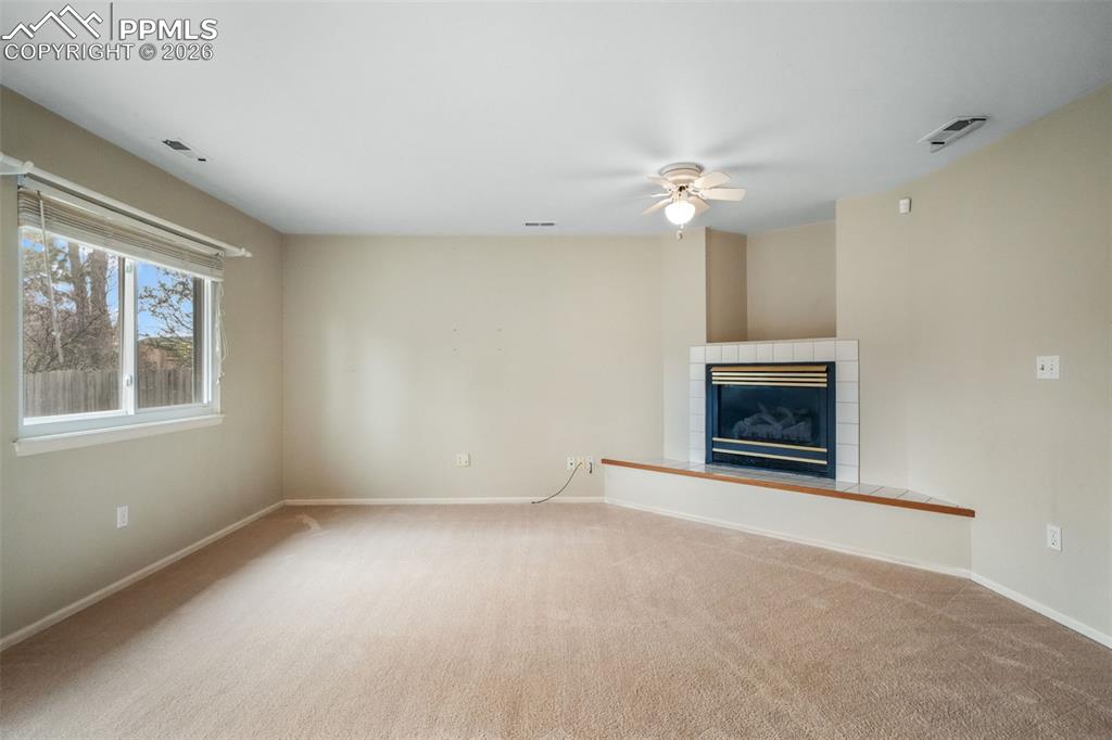 Image 17 of 45: Open-concept interior featuring wood-finish flooring, a two-story ceiling, 