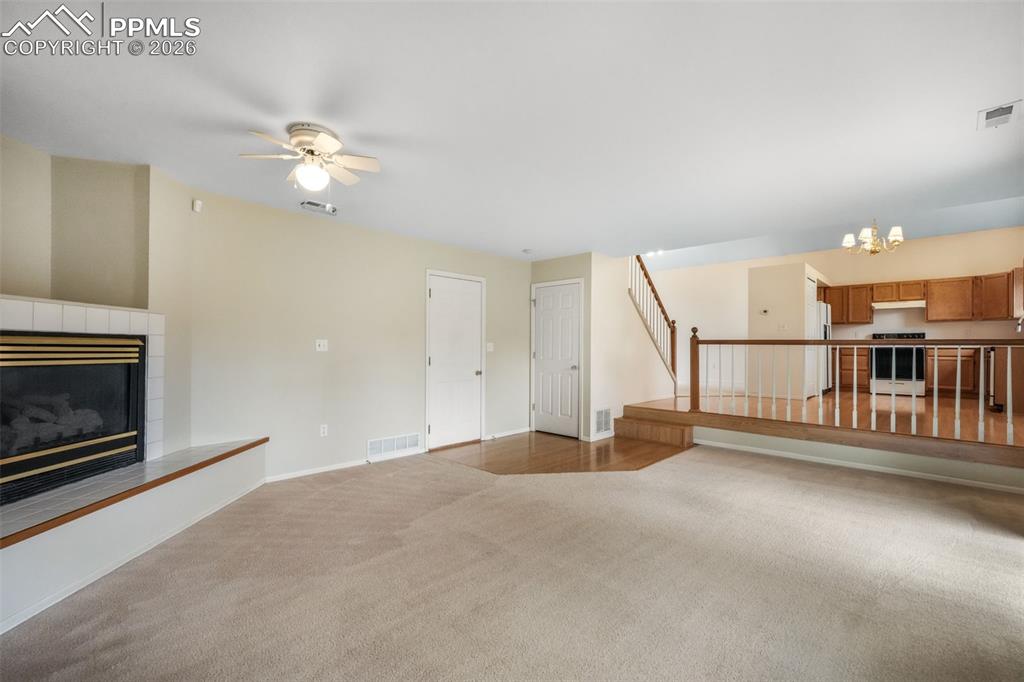 Image 18 of 45: Vaulted ceiling entry with a brass chandelier, wood-finish flooring, and a 