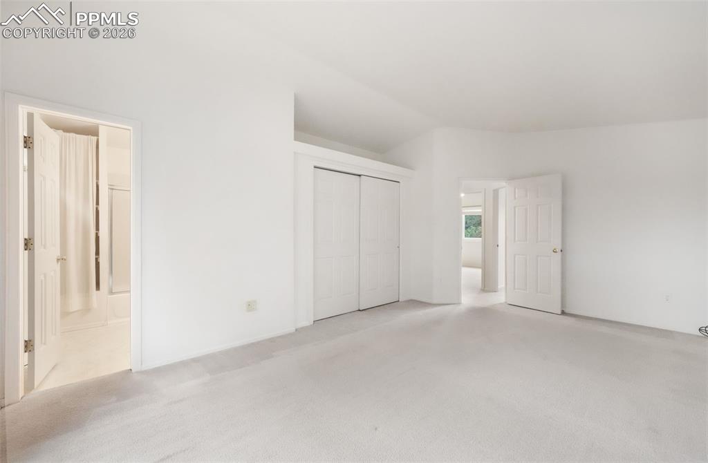 Image 20 of 45: Carpeted living area featuring a tile-surround fireplace with a hearth, a c