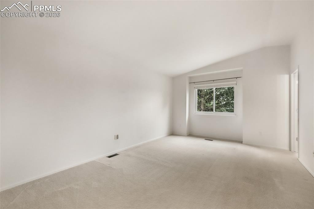 Image 23 of 45: Sunlit living space featuring a sliding glass door, an expansive window, an