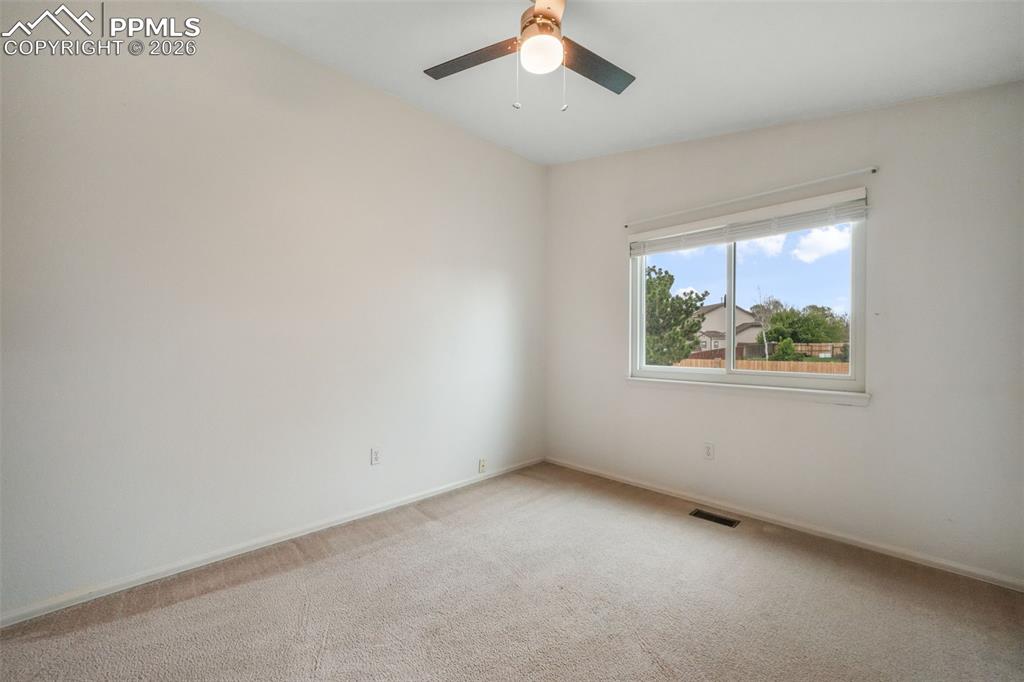 Image 27 of 45: Spacious room featuring sloped ceilings, light-toned carpeting, a window wi