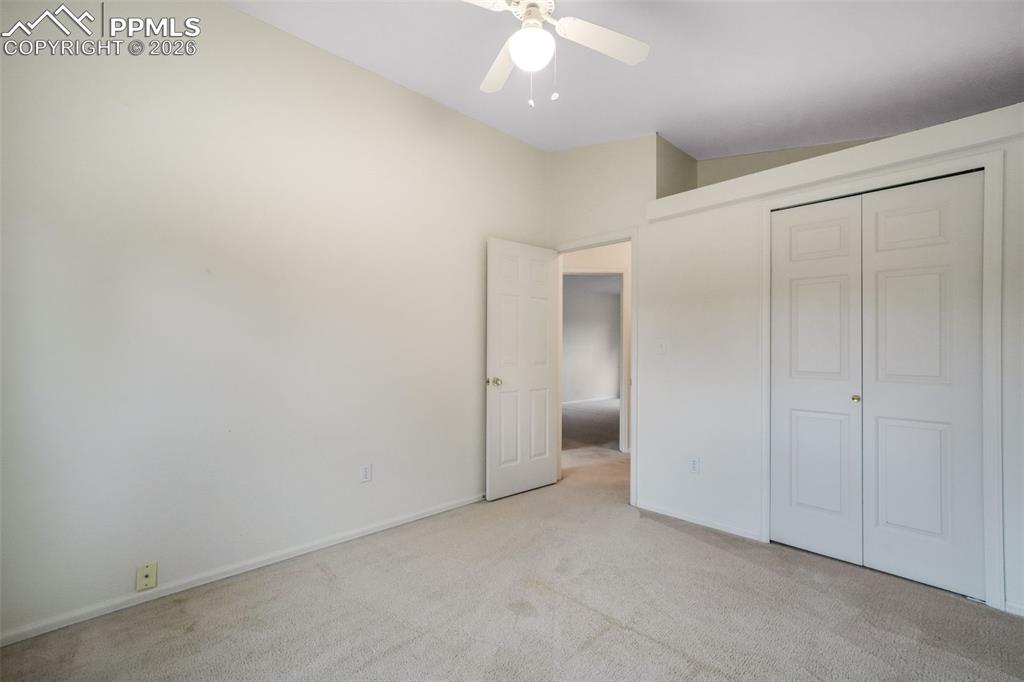 Image 30 of 45: Neutral carpeting and light-toned walls define this room, featuring a ceili