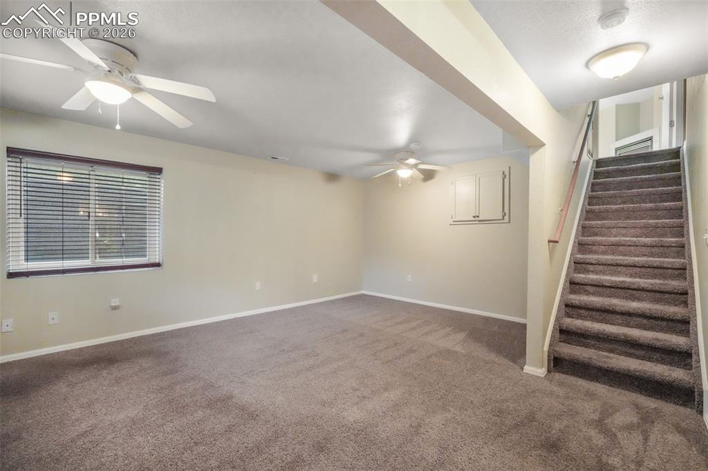 Image 33 of 45: Bright interior space with light-toned walls and neutral carpeting