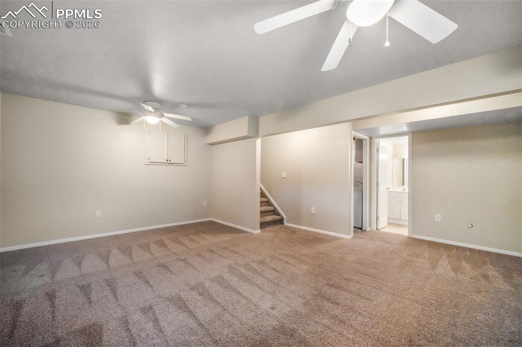 Image 36 of 45: Room featuring a vaulted ceiling and neutral-toned carpeting