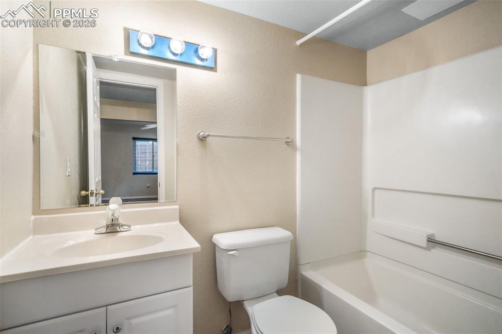 Image 37 of 45: Carpeted lower-level room featuring a window with blinds, ceiling fans, bui