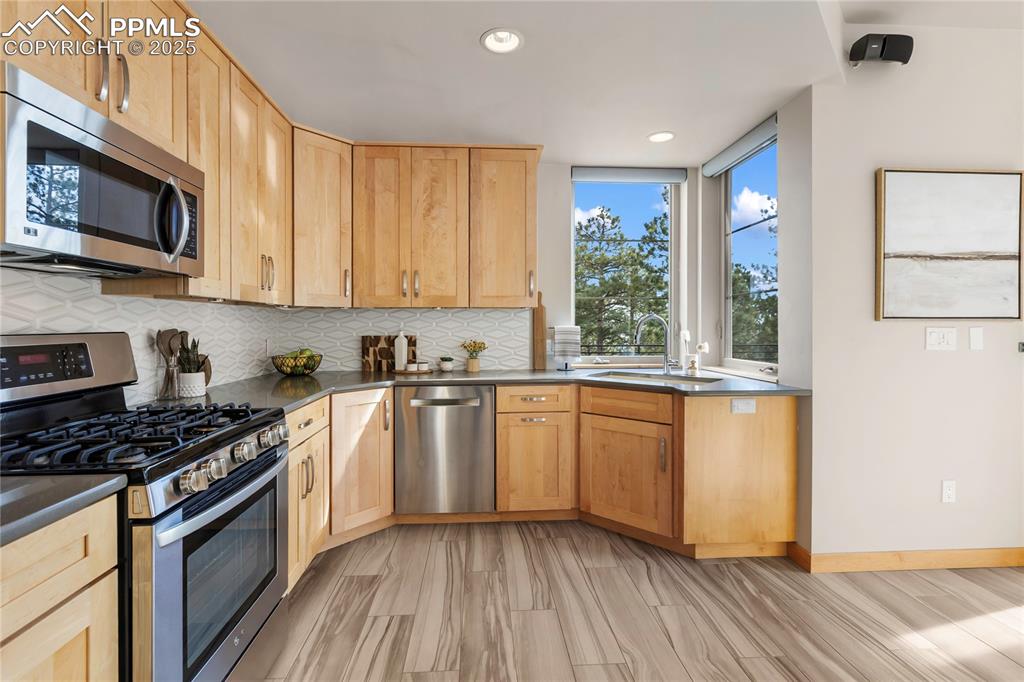 Image 17 of 43: Stainless appliances, gas stove, and those views....we could wash dishes fo