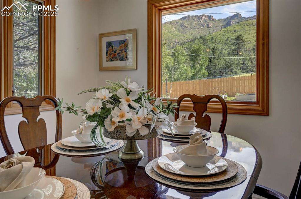 Image 15 of 50: Gorgeous mountain and tree views from the Dining Room windows.
