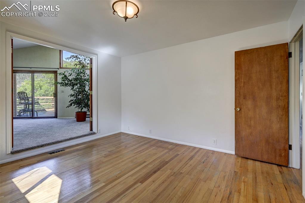 Image 25 of 50: French doors into a private Sitting Room with a slider to the front deck.