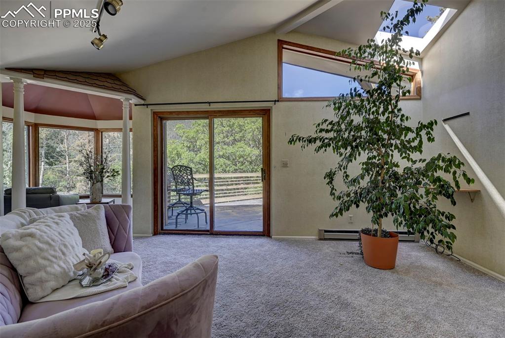 Image 26 of 50: The Sitting Room off the Primary Bedroom features a bay window, skylight, a