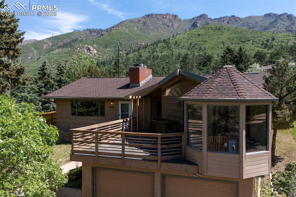 Image 3 of 50: A large front-yard deck sets the tone for peaceful mornings & sunset evenin