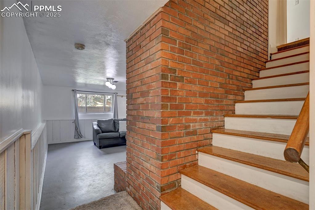 Image 37 of 50: Brick chimney and stairs to the Garden Level Basement.