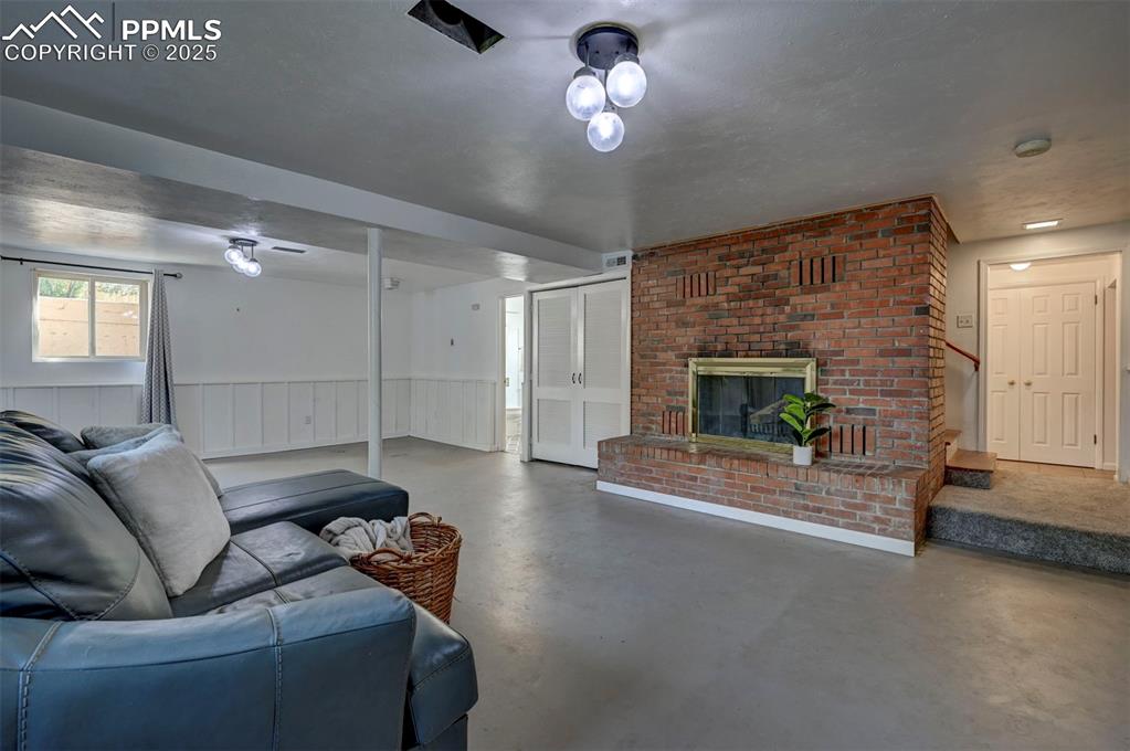 Image 38 of 50: The finished Garden-Level Basement features painted concrete floors and a s