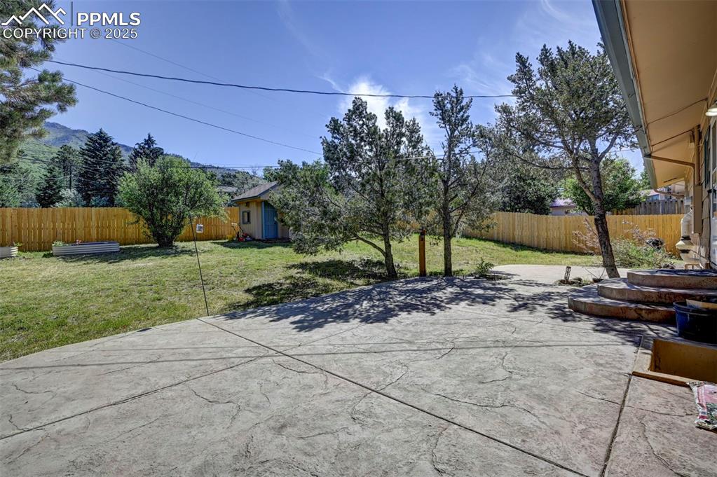 Image 47 of 50: Expansive stamped concrete patio for outdoor dining, entertaining, and rela