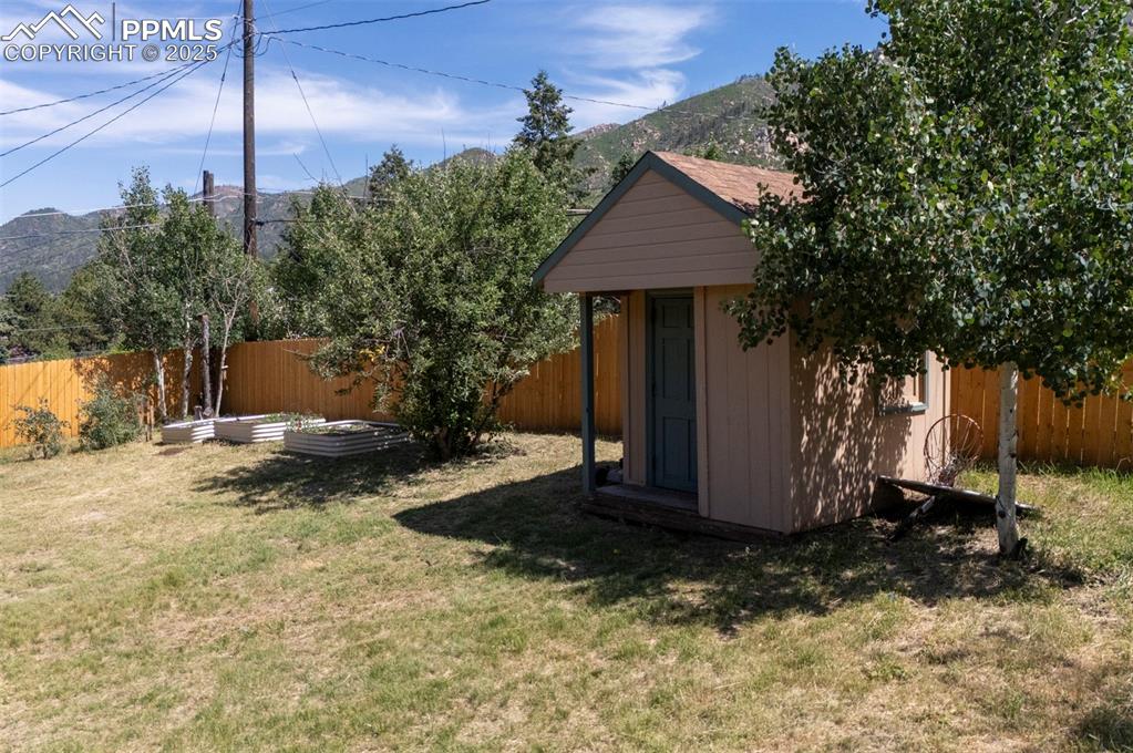 Image 48 of 50: Storage shed for tools and toys.