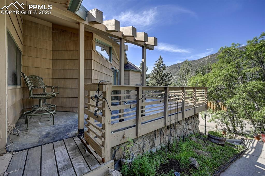 Image 6 of 50: Entry off the front walk way to the front yard deck.