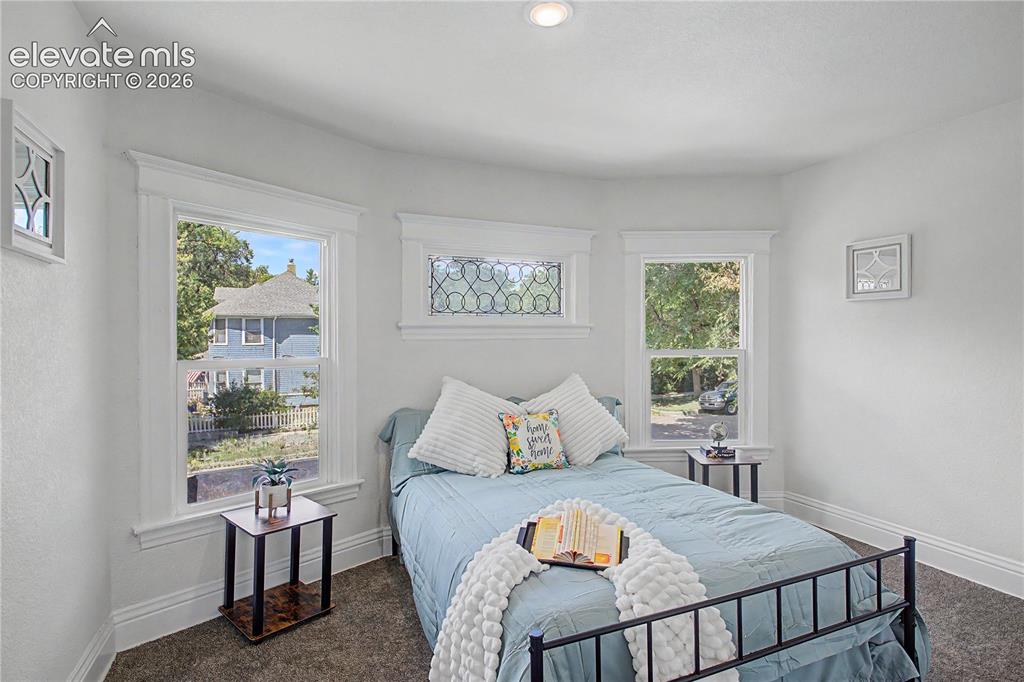 Image 26 of 35: Recessed ceiling lighting, white wall paint, two single-hung windows with w