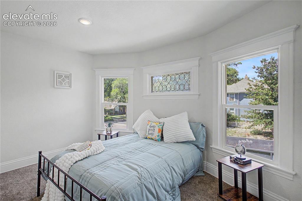 Image 28 of 35: Recessed ceiling lighting, white painted walls, window with detailed casing