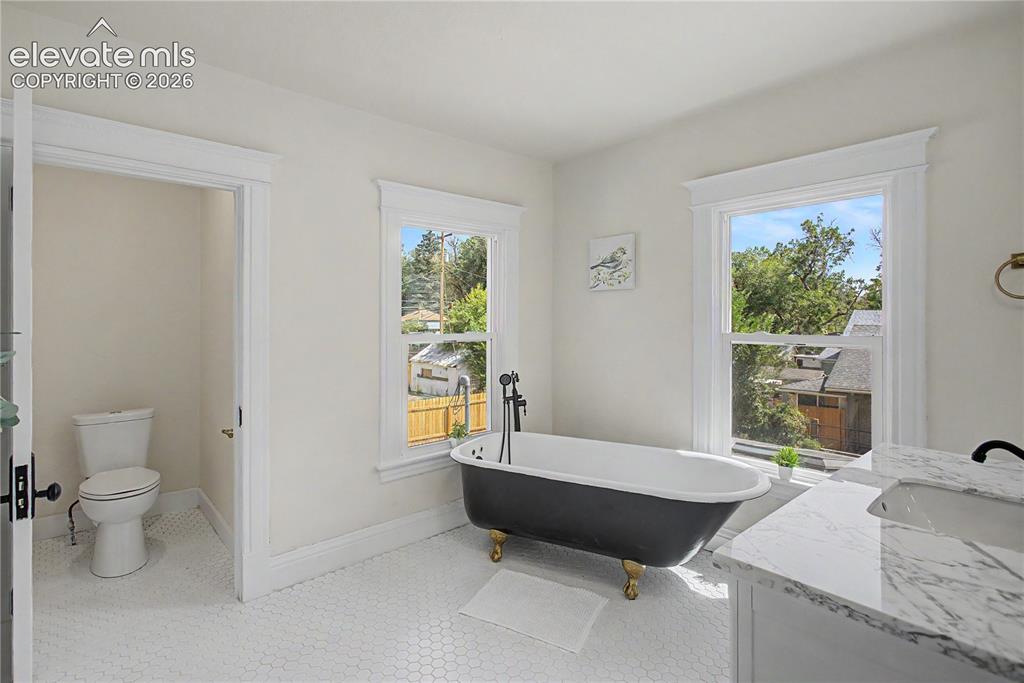 Image 31 of 35: White hexagon tile flooring
