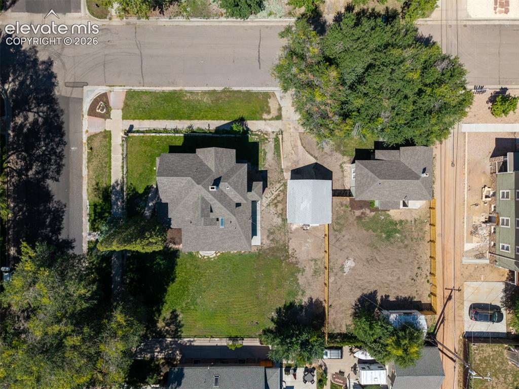 Image 33 of 35: Multi-gabled roofline with skylights, extensive paved driveway, detached au