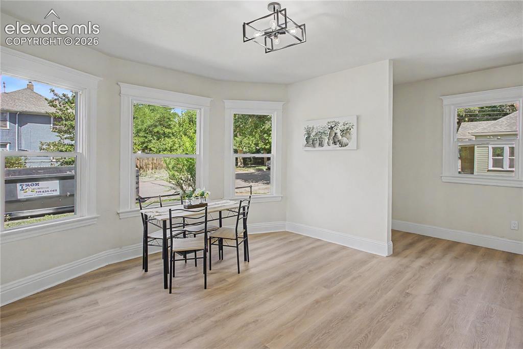 Image 9 of 35: Wood-finish flooring, multiple windows, a ceiling-mounted light fixture, an