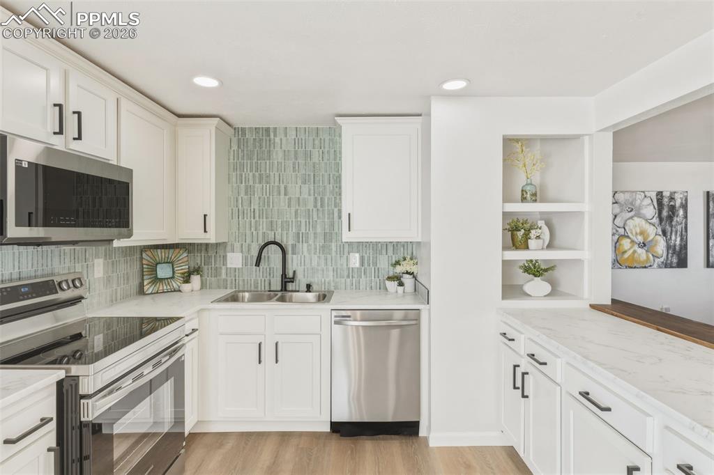 Image 11 of 35: Designer kitchen with tile backsplash