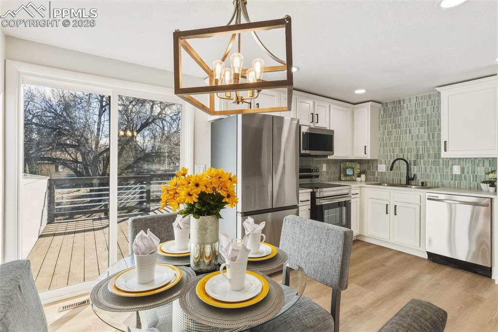 Image 14 of 35: Chic dining under statement lighting