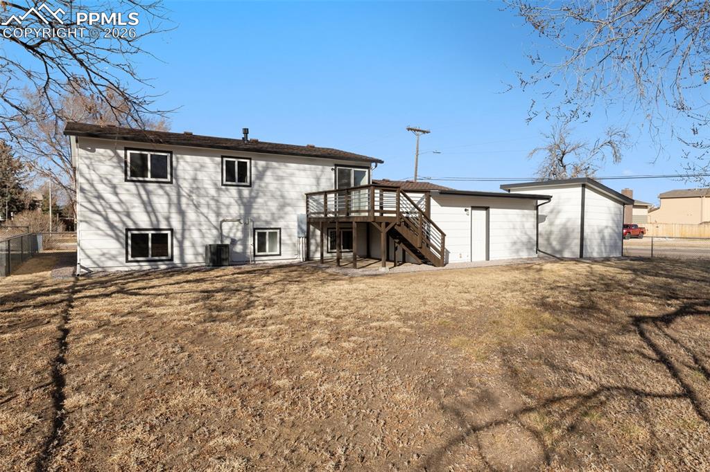 Image 32 of 35: Expansive backyard with deck