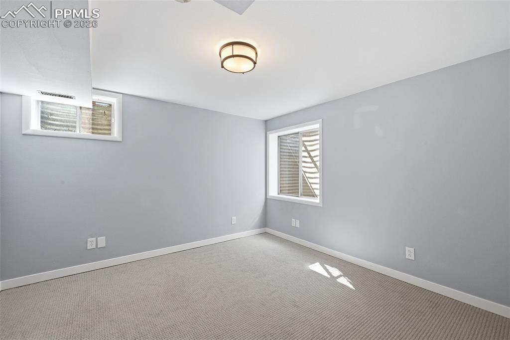 Image 22 of 44: Basement bedroom. 
