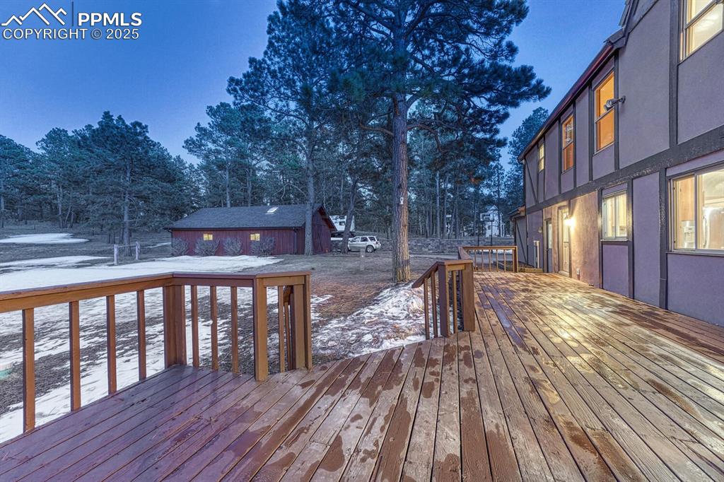 Image 32 of 47: Snow covered deck featuring an outbuilding