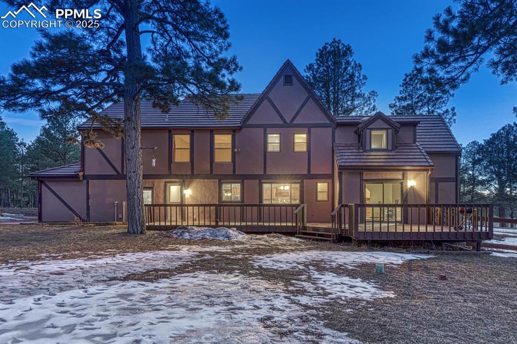 Image 36 of 47: Snow covered property with a tile roof and stucco siding