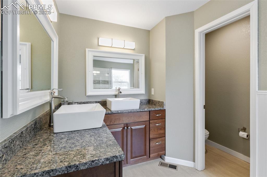 Image 22 of 41: Bathroom featuring double vanity and toilet