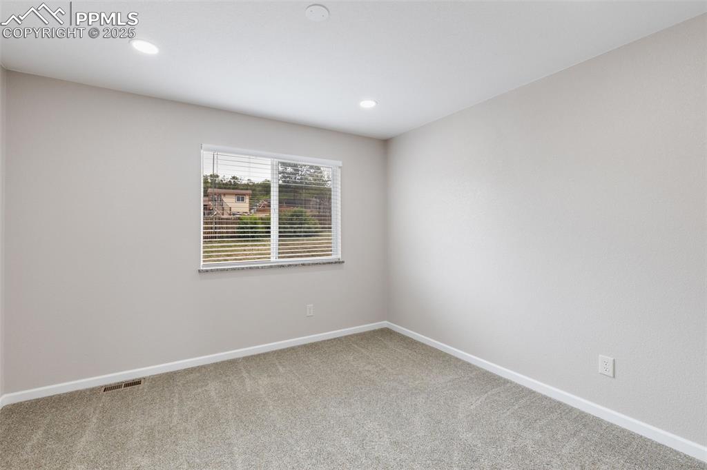 Image 23 of 41: Unfurnished room with carpet floors and recessed lighting