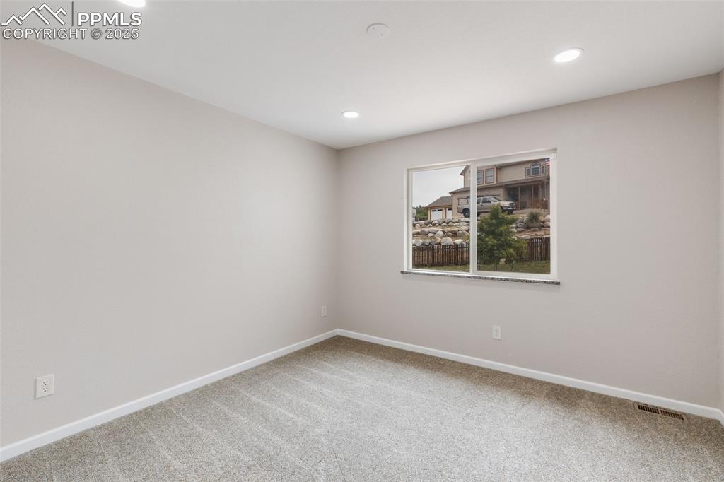 Image 25 of 41: Carpeted spare room with baseboards and recessed lighting