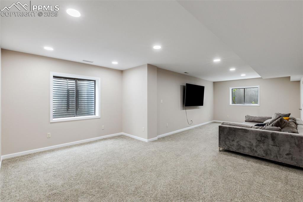 Image 29 of 41: Carpeted living room with recessed lighting