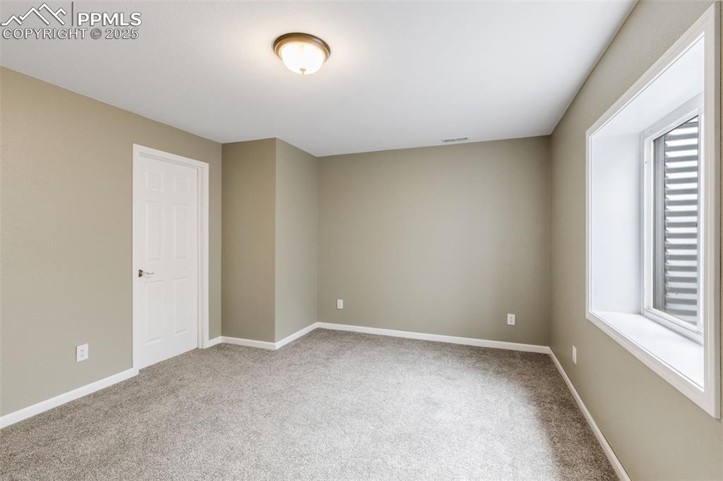 Image 31 of 41: Carpeted empty room featuring baseboards