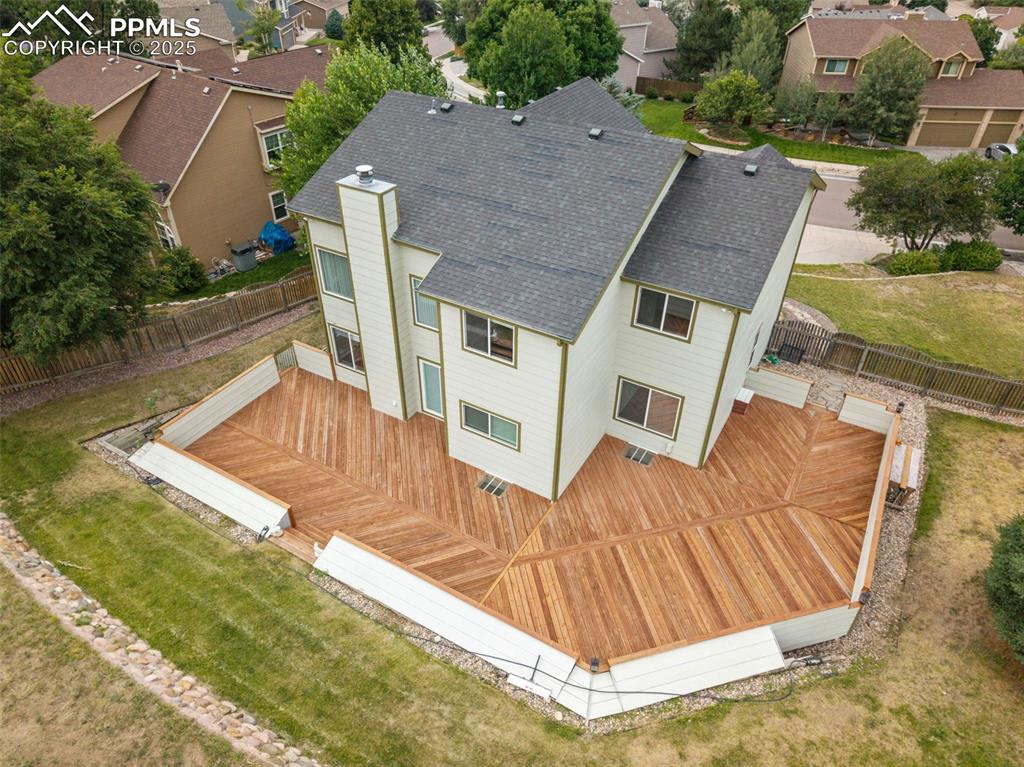 Image 39 of 41: Back of property with a shingled roof, a fenced backyard, a deck, and a res