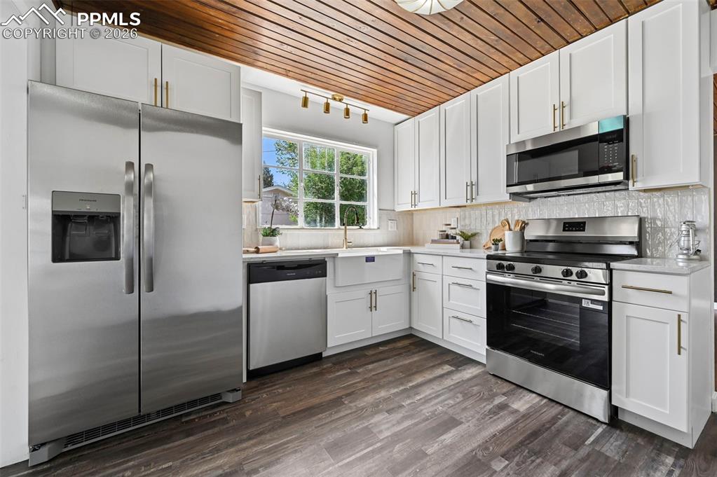 Image 2 of 21: Beautifully new kitchen featuring a stone counters, new cabinets, and look 