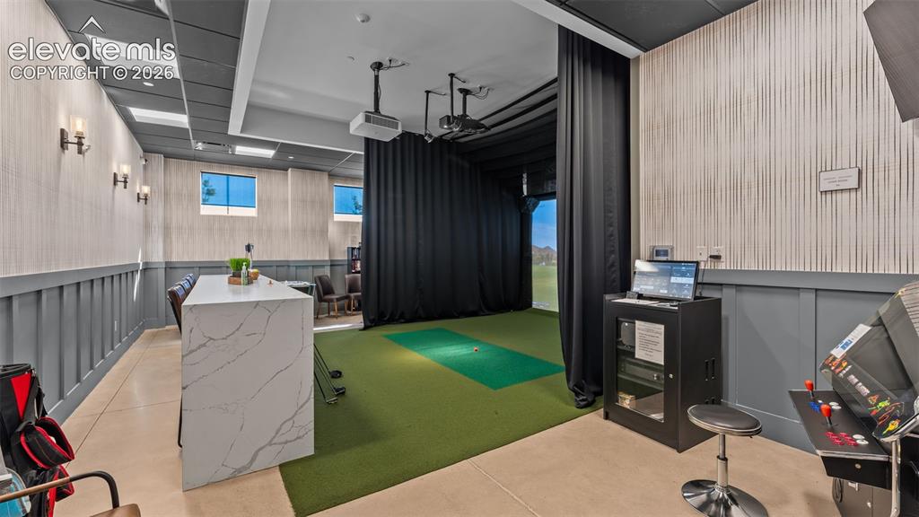 Image 30 of 46: Golf simulator in the community clubhouse.