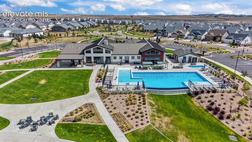 Image 32 of 46: Community clubhouse, pool, hot tub, outdoor seating and concert area.