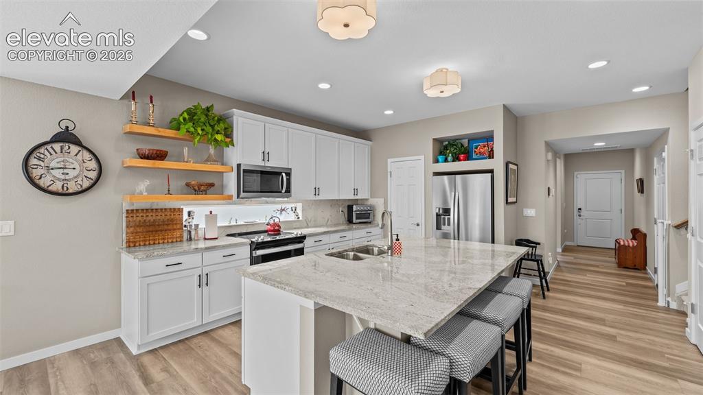 Image 4 of 46: Stainless steel appliances, granite countertops and breakfast seating.