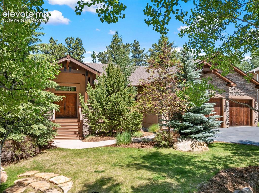 Image 1 of 50: Enjoy the beautiful, mature, professionally landscaped front yard with an a