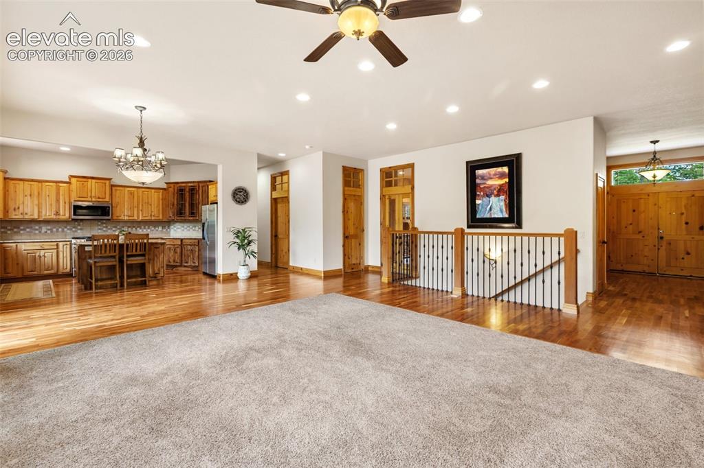 Image 10 of 50: The living room opens to a casual dining area and the spacious kitchen.