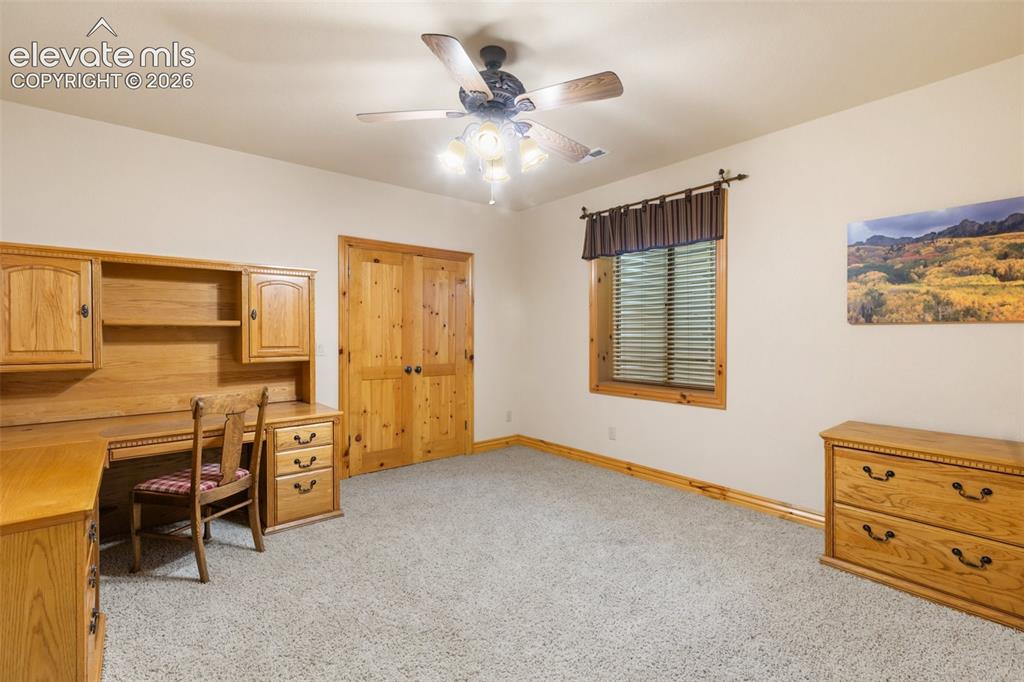 Image 35 of 50: Lower level 6th bedroom with oversized walk in closet with built in shelves